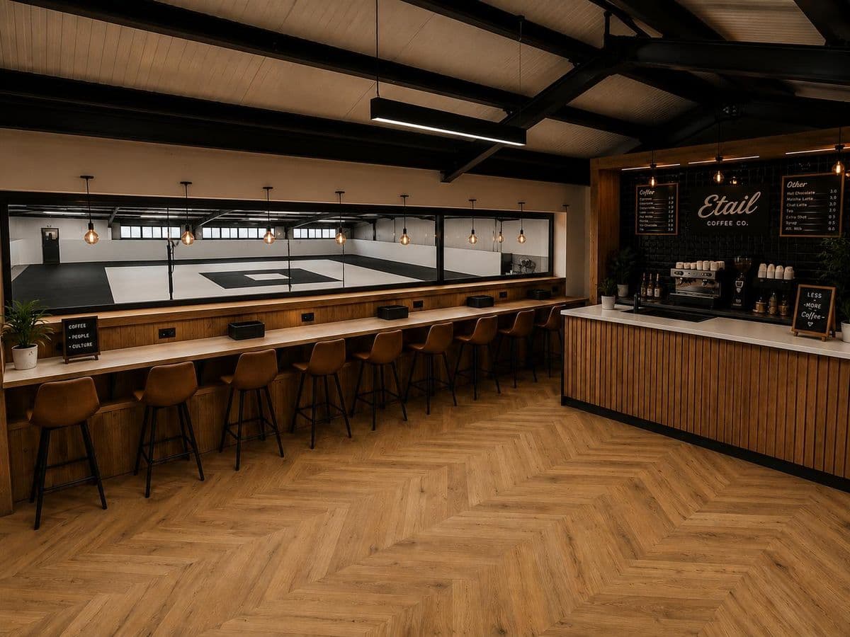 The café counter and a long bar of stools looking through a window onto the mat